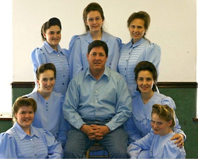 Lyle Jeffs with seven of his wives posed for a photoshoot.